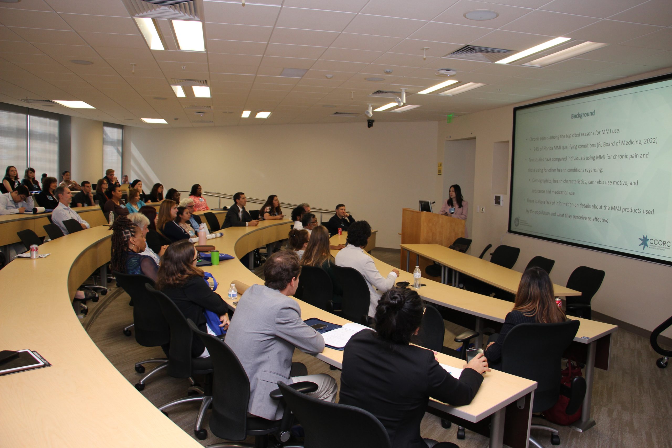 An audience of attendees sitting in a lecture hall